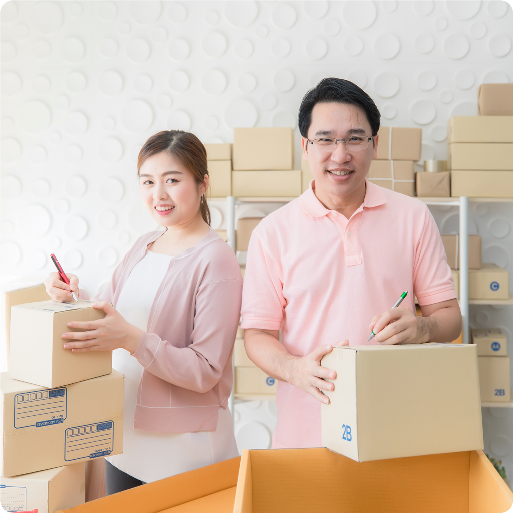 male-female-staff-writing-address-front-package-be-shipped